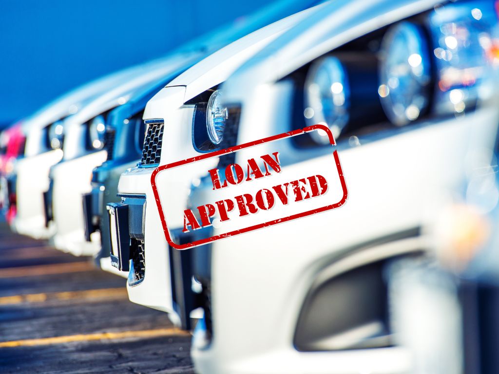 lineup of new cars with a bold red "Loan Approved" stamp, signifying successful auto loan applications.