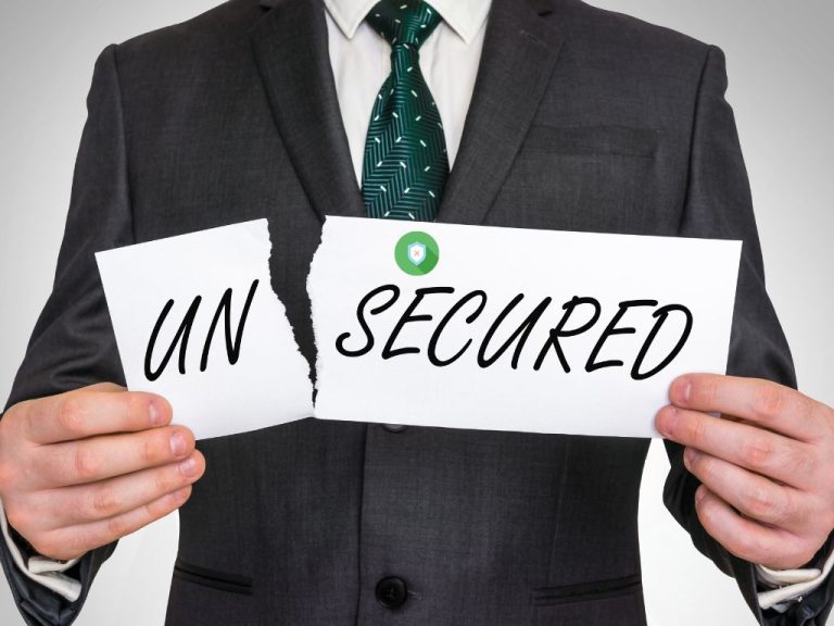 A businessman holding a torn paper with "Unsecured" split in two, representing the difference between unsecured and secured loans.