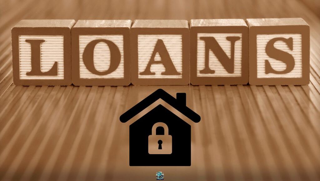 “Wooden blocks spelling ‘LOANS’ with a house and lock icon, symbolizing the concept of secured loans where assets are used as collateral.”